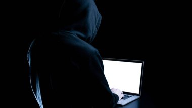 Siber güvenlik korsanı konsepti. İnternet hackleme teknolojisi. Bilgisayar korsanının elindeki dijital dizüstü bilgisayar siyah pankartta izole edilmiş. Veri koruması, güvenli internet erişimi, siber güvenlik