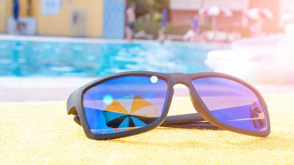 방학때는 선글라스가 수건에 선글라스쓴 바다에서의 — 스톡 사진