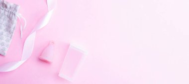 Menstrual cramp, use menstrual cup inside vagina. Pink ribbon with menstrual cup. Menstruation feminine period. Medical healthcare gynecological banner