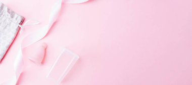 Menstrual cycle sanitary cup. Pink ribbon with menstrual cup. Menstruation feminine period. Sanitary hygiene banner. Use menstrual cup inside vagina