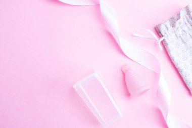 Menstrual cycle sanitary cup. Pink ribbon with menstrual cup. Menstruation feminine period. Sanitary hygiene banner. Use menstrual cup inside vagina