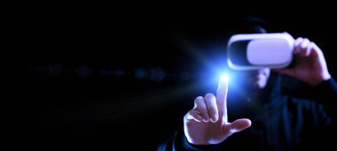 VR gözlükleri sanal gerçekliği gözlüyor. Karanlık arka planda üç boyutlu sanal gerçeklik oyunu için dijital başlıklı genç adam. 3 boyutlu simülasyonda çalışma ve sanal dünya