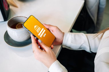 Çevrimiçi ödeme. İnternet banka uygulamalı akıllı telefonu olan bir kadın. Banka kartı cüzdanı uygulaması. Para cüzdanını kaydet