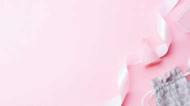 Menstrual cycle sanitary cup. Pink ribbon with menstrual cup. Menstruation feminine period. Sanitary hygiene banner. Use menstrual cup inside vagina