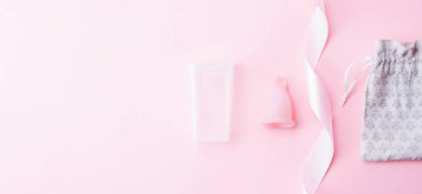Menstrual cramp, use menstrual cup inside vagina. Pink ribbon with menstrual cup. Menstruation feminine period. Medical healthcare gynecological banner