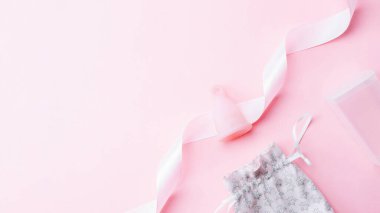Menstrual cycle sanitary cup. Pink ribbon with menstrual cup. Menstruation feminine period. Sanitary hygiene banner. Use menstrual cup inside vagina