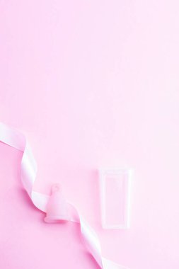 Menstrual cycle sanitary cup. Pink ribbon with menstrual cup. Menstruation feminine period. Sanitary hygiene banner. Use menstrual cup inside vagina
