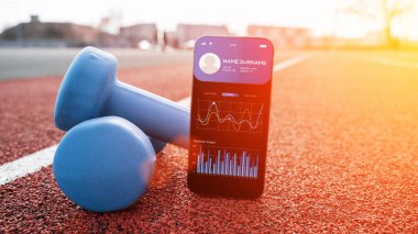 Spor salonu başvurusu. Spor salonunun arka planında spor salonu mobil uygulaması olan akıllı telefon ekranı. Çevrimiçi fitness programı