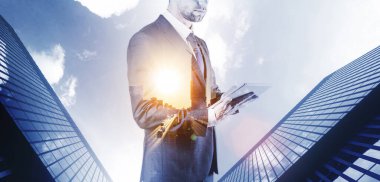 Businessman using tablet double exposure. Young business man analyzing economic growth graph chart and data sales. Digital marketing technology banner