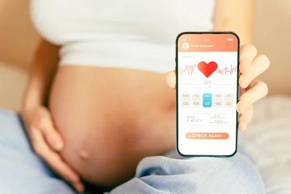 Pregnancy health app. Pregnant woman holding smartphone. Mobile pregnancy online maternity application. Concept of pregnancy, maternity, expectation for baby birth