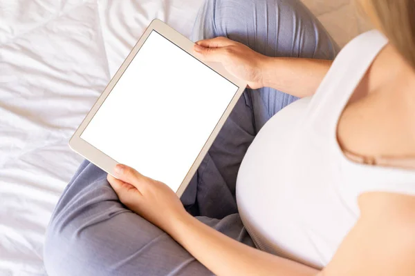 Pregnancy mockup digital tablet. Pregnant woman holding smart tablet. Mobile pregnancy online maternity application mock up. Concept maternity, pregnancy, childbirth