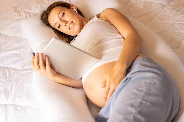 Pregnancy health app. Pregnant woman holding digital tablet. Mobile pregnancy online maternity application. Concept maternity, pregnancy, childbirth