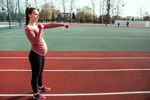 Prenatal exercises. Prenatal healthy fitness active fit gym outside. Pregnant woman training yoga sport exercise. Pregnancy training