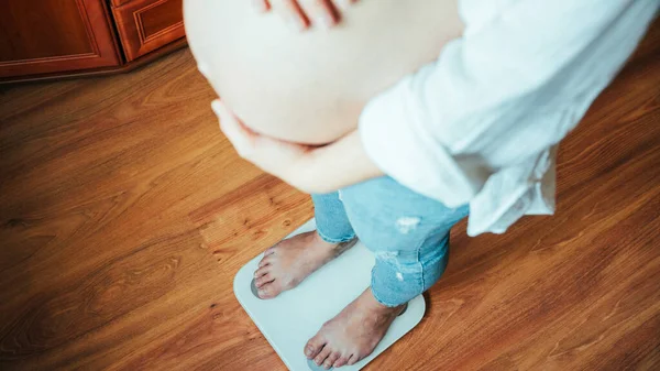 妊娠期体重增加 快乐的孕妇站在举重秤上 概念孕产 — 图库照片