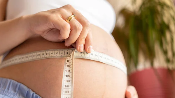 测量怀孕妇女的身体 快乐美丽的怀孕妇女与带测量腹部 预期分娩的概念 — 图库照片