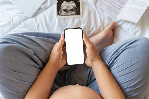 Pregnancy screen mockup. Mobile pregnancy online maternity application mock up. Pregnant mother using phone. Concept of pregnancy, maternity, expectation for baby birth