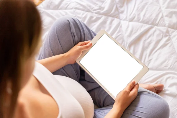 Pregnancy mockup digital tablet. Pregnant woman holding smart tablet. Mobile pregnancy online maternity application mock up. Concept maternity, pregnancy, childbirth