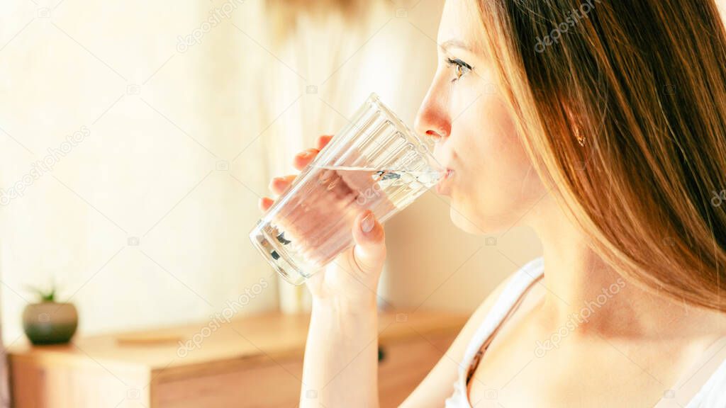 Pregnant water drinking woman. Young pregnancy mother drink water. Pregnant lady waiting of baby. Glass of water. Concept of maternity, expectation