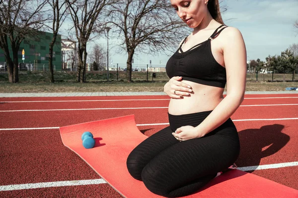 Pregnancy health. Prenatal healthy fitness active fit gym outside. Pregnant woman training yoga sport exercise. Pregnancy yoga exercise