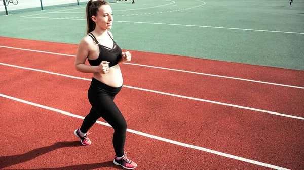 Pregnancy running. Prenatal healthy fitness active fit gym outside. Pregnant woman training yoga sport exercise. Pregnancy exercise
