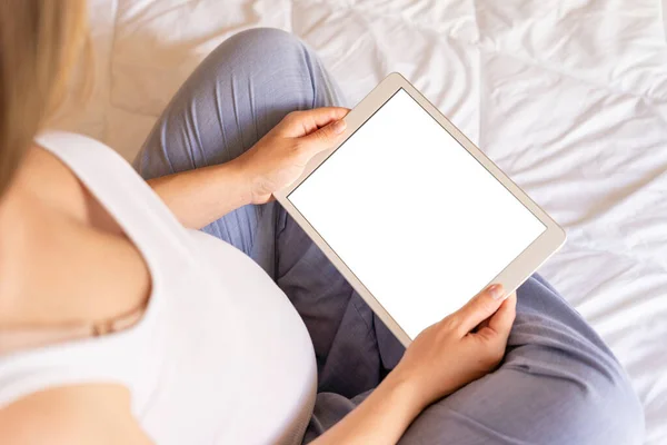 Pregnancy digital tablet screen. Pregnant woman holding smart tablet mock up. Mobile pregnancy online maternity application. Concept of pregnancy, maternity, expectation for baby birth