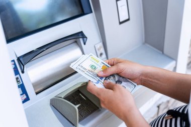 Atm money cash machine. Woman withdraw money bill. Holding american hundred dollar cash. Bank credit card, us dollar