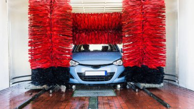 Car washing automatic carwash. Brush washer clean blue auto car on automatic car wash station. Carwash cleaning service