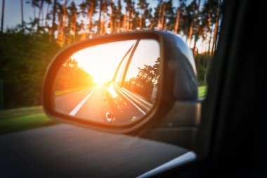 Road trip car mirror. Sun, highway car road reflection in mirror. Summer holidays trip concept
