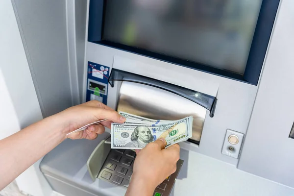 Atm card machine cash. Holding american bill cash. Woman withdraw money usd hundred dollar. Bank credit card money background