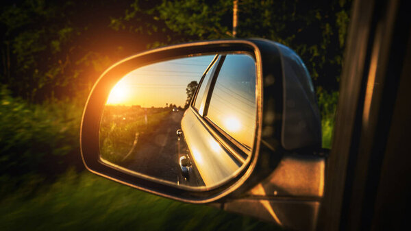 Road trip car mirror. Sun, highway car road reflection in mirror. Summer holidays trip concept