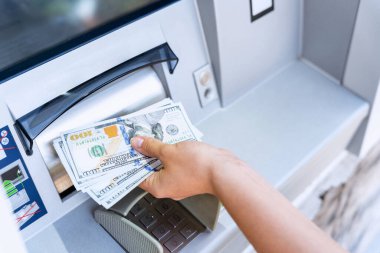 Atm machine money cash. Woman withdraw money bill. Holding american hundred dollar cash. Bank credit card and dollar bill