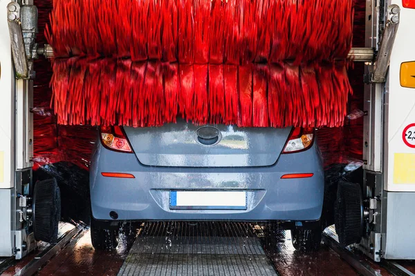 Car wash automatic carwash. Brush washer clean blue auto car on automatic car wash station. Auto carwash machine background