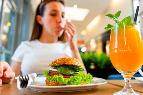 Vegan burger healthy vegetarian hamburger. Salad, avocado, vegetable on veggie sandwich eating cute woman. Vegetarian hamburger healthy diet food
