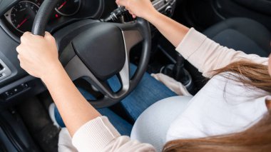 Pregnant woman driver. Beautiful smiling pregnancy woman driving car. Safety pregnant young mother drive concept