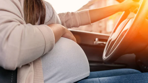 Pregnancy woman driving car. Young smiling pregnant woman driving car. Safety pregnancy young mother drive concept