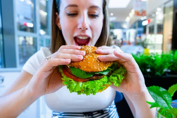 Vegan burger healthy vegetarian hamburger. Salad, avocado, vegetable on veggie sandwich eating cute woman. Vegetarian hamburger healthy diet food