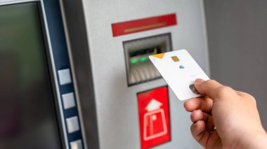Atm card cash machine. Hand holding money bank credit card. Withdraw money cash from atm. Bank credit card money background