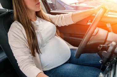 Pregnancy driving car. Young beautiful pregnant woman driving car. Safety pregnancy, mother health care concept