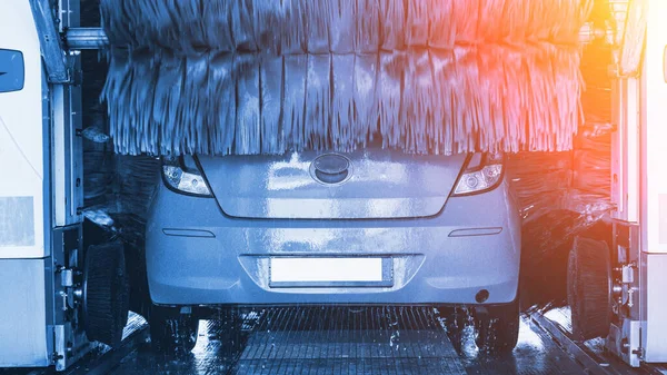 Car wash automatic carwash. Brush washer clean blue auto car on automatic car wash station. Auto carwash machine background