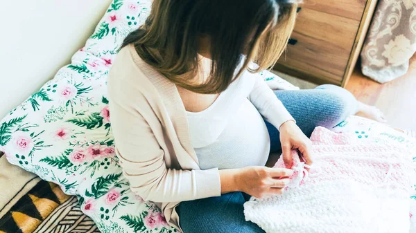 Knitting socks pregnancy woman. Pregnant mother crochet kid cloth. Cute pregnancy woman knit fashion winter baby girl clothes. Cozy knitting woman