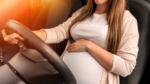 Pregnant woman driver. Beautiful smiling pregnancy woman driving car. Safety pregnant young mother drive concept