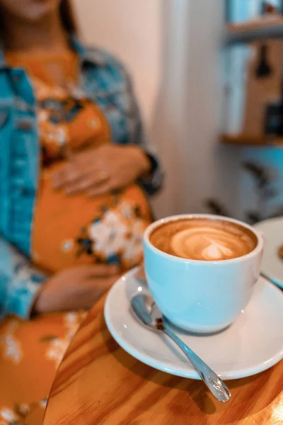 Pregnant woman coffee drink. Lifestyle morning with happy pregnancy girl drink espresso coffee. Represent breakfast, energy, freshness or great aroma concept