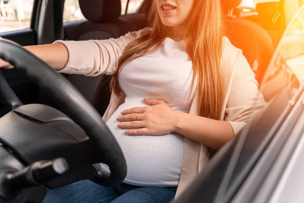Pregnancy driving car. Young beautiful pregnant woman driving car. Safety pregnancy, mother health care concept