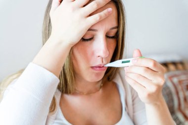 Pregnant sick fever thermometer. Pregnancy woman holding thermometer, check fever flu temperature. Pregnant girl sick. Pregnancy, medicine health care concept