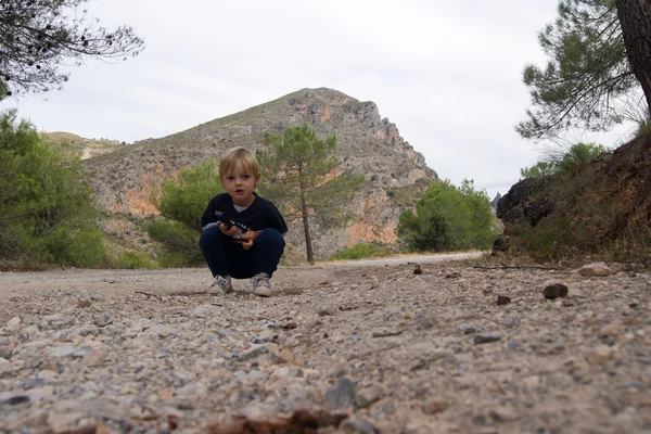 Baby sitting on a forest path — Stock Photo, Image