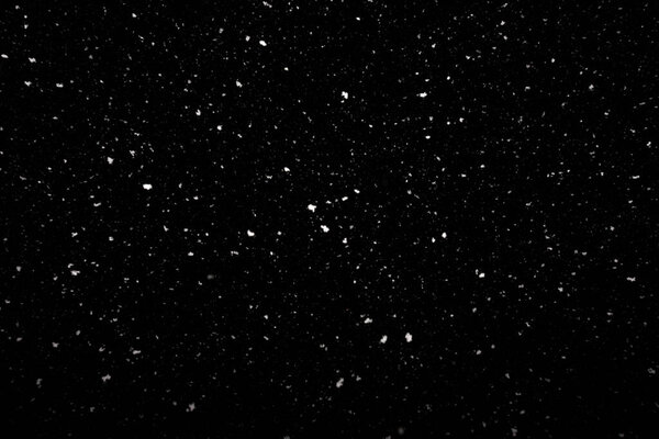 Falling snow texture isolated on black background