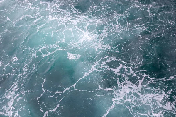 Surface de l'eau. Réveillez les vagues et la mousse sur l'eau de mer bleue — Photo