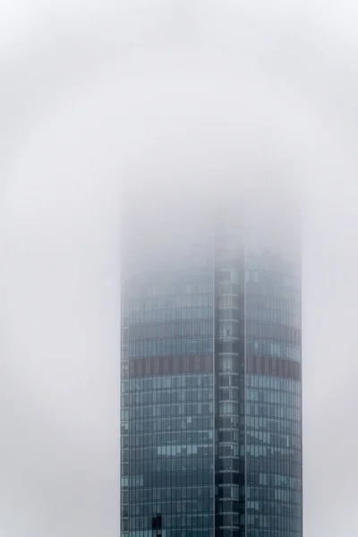 The modern Skyscraper is hidden in the fog. Hiding in the Fog