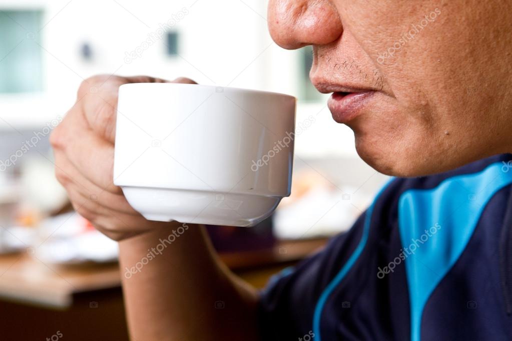 Man taking a break by drinking tea