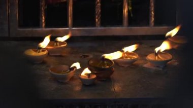 Burning diyas oil lamp on an altar inside a Hindu temple. Diwali festival or hindu prayers concept.